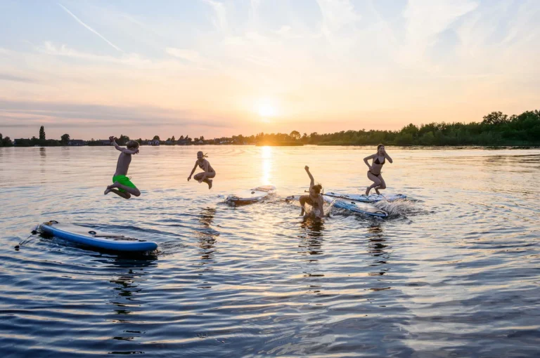 Children jumping from their sups